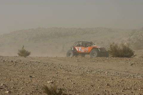 1992 Jeep Wrangler - Off-road buggy navigates a dusty desert course during an event.
