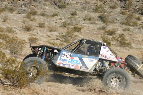1992 Jeep Wrangler - A custom-built off-road buggy navigates a dusty desert terrain during a race event.