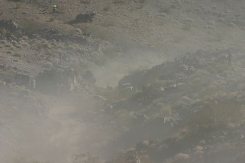 1992 Jeep Wrangler - Dust clouds obscure the view of off-road vehicles traversing a , arid landscape.