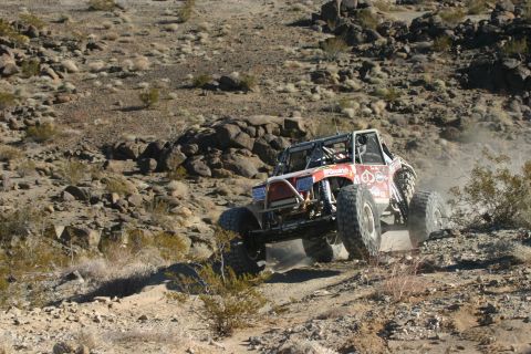1992 Jeep Wrangler - Custom off-road buggy navigates a challenging desert terrain during an event.