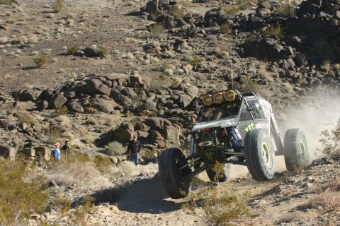 1992 Jeep Wrangler - Custom off-road buggy navigates a dusty, rocky desert terrain during an event.