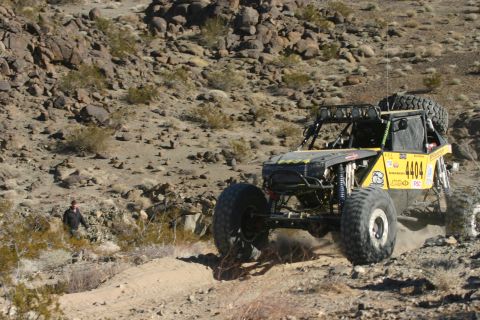 1992 Jeep Wrangler - Custom off-road buggy navigates a rocky, desert landscape during an event.