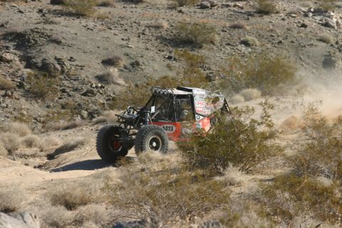 1992 Jeep Wrangler - Off-road buggy navigates a dusty desert course during a race.