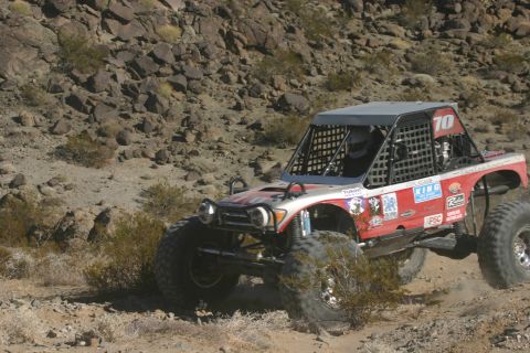 1992 Jeep Wrangler - A custom-built off-road buggy navigates a challenging desert course during a race.