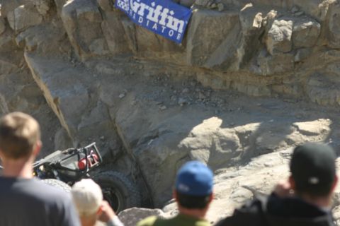1992 Jeep Wrangler - A custom off-road vehicle navigates a challenging rocky terrain, observed by onlookers.