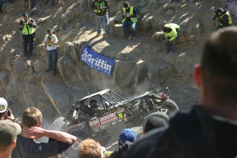 1992 Jeep Wrangler - Spectators watch an off-road buggy tackle a challenging climb at an event.
