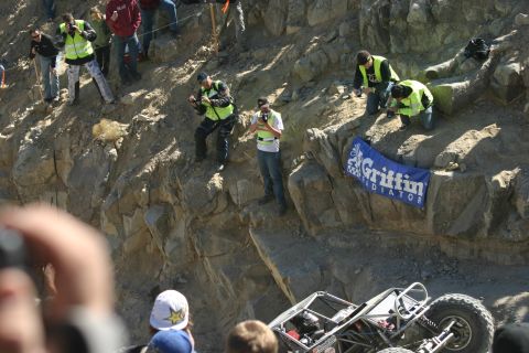 1992 Jeep Wrangler - Spectators watch an off-road buggy navigate a rocky course, with a Griffin Radiator banner visible.