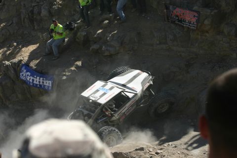 1992 Jeep Wrangler - An off-road buggy navigates a challenging rocky terrain during a competition.