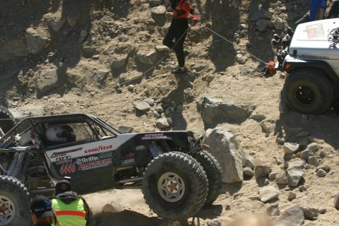 1992 Jeep Wrangler - Two off-road vehicles navigate a challenging rocky terrain during an event.