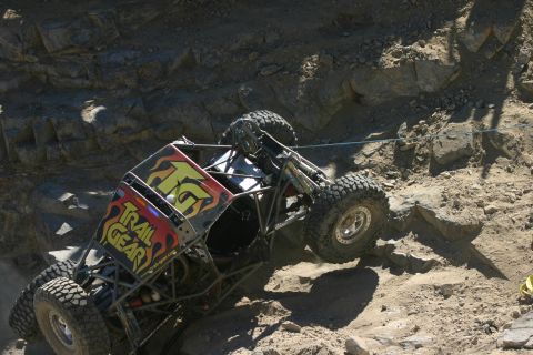 1992 Jeep Wrangler - Custom off-road buggy navigates a rocky incline during an event.