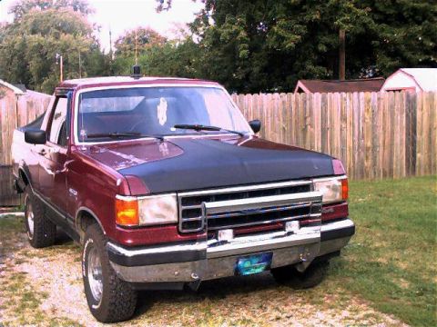 1990 Ford Bronco - This Ford pickup truck, likely from the late 1980s, is shown from a three-quarter front angle.