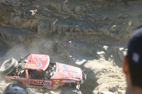 1992 Jeep Wrangler - A heavily modified off-road vehicle navigates a challenging rocky terrain during a competition.