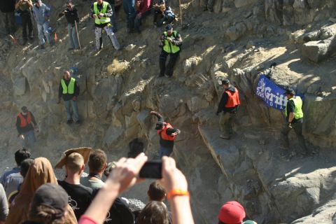 1992 Jeep Wrangler - Event participants and spectators gather on a rocky slope, with a media banner in the background.