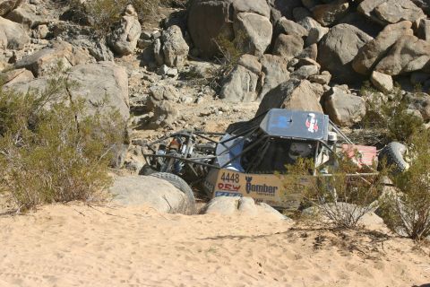 1992 Jeep Wrangler - This off-road buggy, marked with number 4448 and 'Bomber Fabrication', appears stuck in a rocky desert terrain.