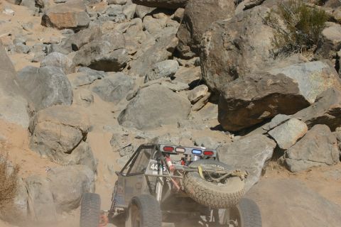 1992 Jeep Wrangler - Buggy tackles a challenging rocky course during an off-road event.