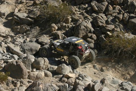 1992 Jeep Wrangler - This heavily modified off-road vehicle navigates a challenging rocky course, likely during an event like KOH 2011.