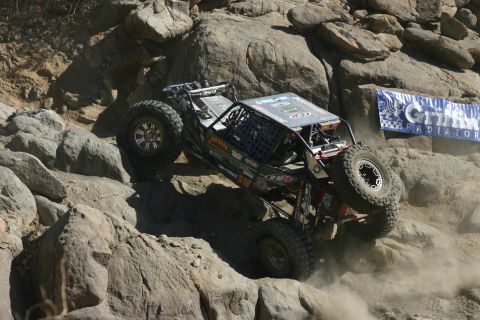1992 Jeep Wrangler - A custom-built off-road buggy navigates a challenging rocky terrain during a competition.