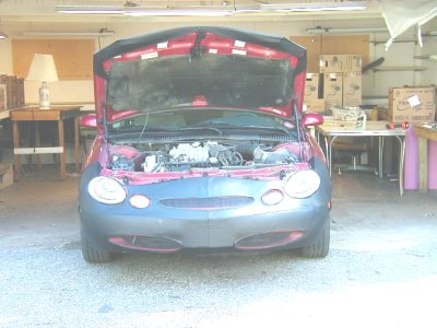 1997 Ford Taurus - Front view of a 1997 Ford Taurus with the hood open, revealing the engine bay.