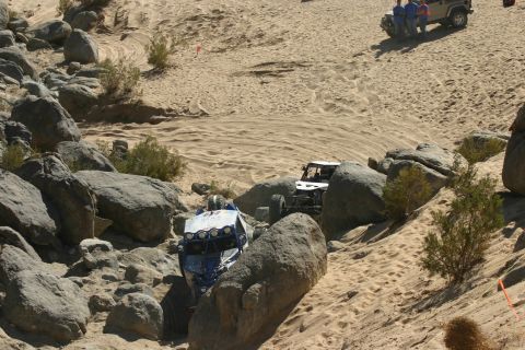 1992 Jeep Wrangler - Off-road vehicles traverse a challenging rocky and sandy course during an event.