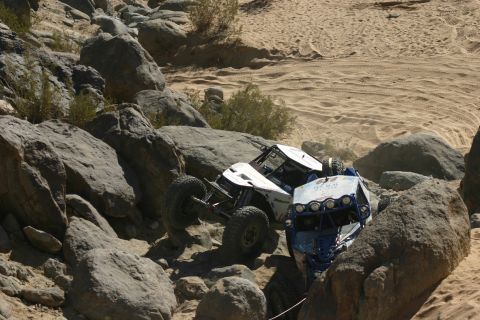 1992 Jeep Wrangler - Two custom off-road buggies tackle a challenging rocky course during an event.