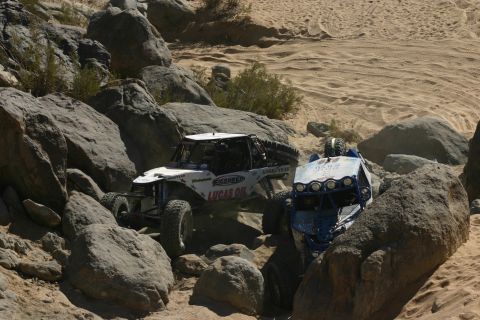 1992 Jeep Wrangler - Off-road vehicles tackle a challenging rocky course in a desert environment.