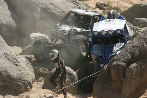 1992 Jeep Wrangler - Off-road vehicles tackle a challenging rocky terrain during a race event.