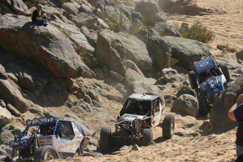 1992 Jeep Wrangler - Off-road vehicles tackle a challenging rocky course during an event.