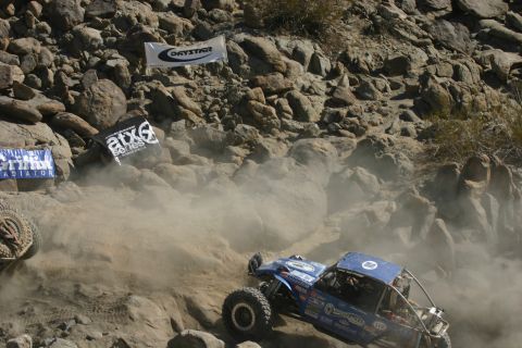 1992 Jeep Wrangler - Off-road buggy navigates a dusty, rocky course during a competition.