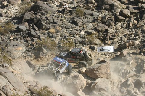 1992 Jeep Wrangler - Off-road vehicles tackle a challenging rocky course during an event.