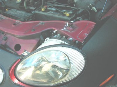1997 Ford Taurus - Front view of a 1997 Ford Taurus engine bay and headlight assembly.