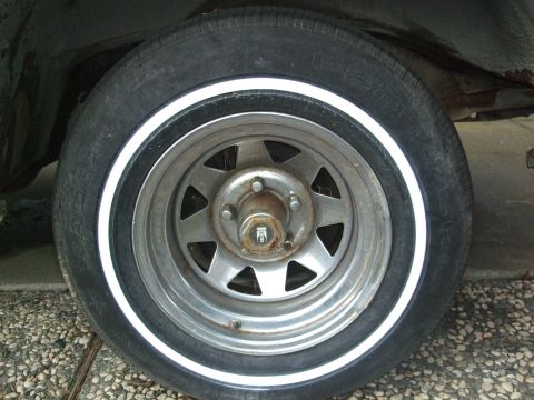 1979 Ford Bronco - Close-up of a vehicle's wheel and tire assembly, a whitewall tire and an aftermarket rim.