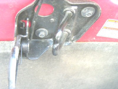 1997 Ford Taurus - Close-up of a car's hood latch mechanism, showing metal components and springs.