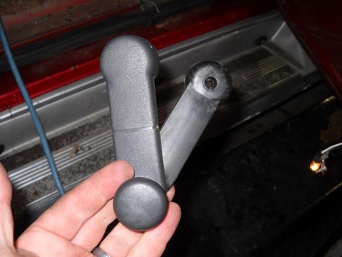 1993 Ford C-150 (Centurion Conversions) - Close-up of a gray plastic interior window crank mechanism.