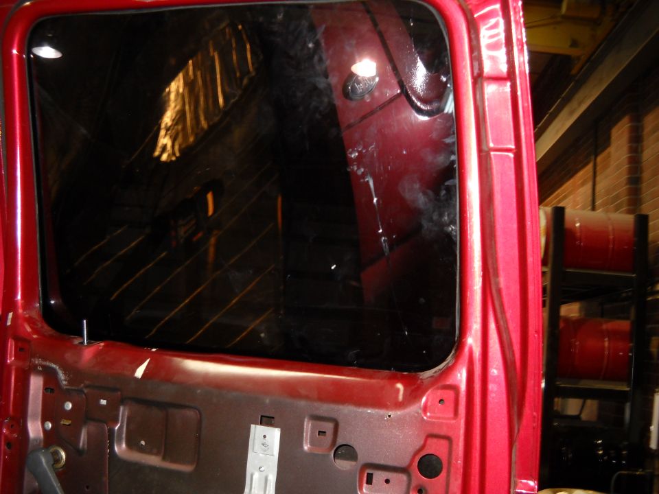 Red truck door interior with tinted window