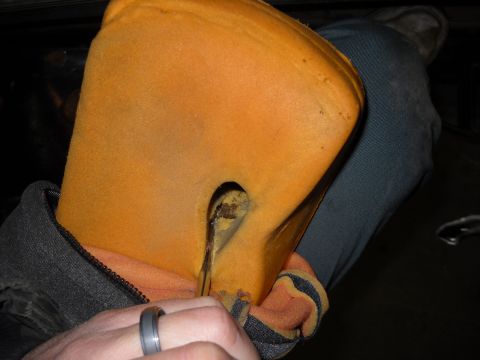 1993 Ford C-150 (Centurion Conversions) - Close-up of damaged car seat foam, showing a tear and exposed metal interior.