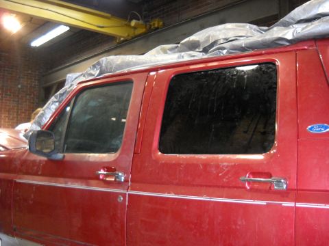 1993 Ford C-150 (Centurion Conversions) - Red 1993 Ford C-150 (Centurion Conversions) SUV in garage, tarp on roof.