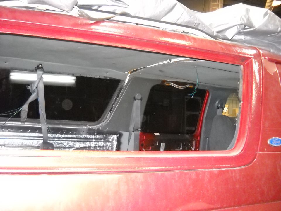 Red van interior, window removed, showing insulation and seats