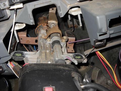 1993 Ford C-150 (Centurion Conversions) - Interior view of a vehicle's steering column assembly, showing mechanical and electrical parts.
