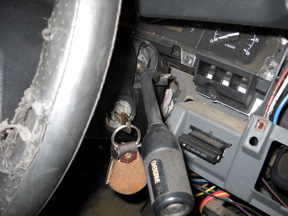 Steering column with keys in ignition, dashboard gauges, and overdrive lever in a 1993 Ford C-150 (Centurion Conversions)