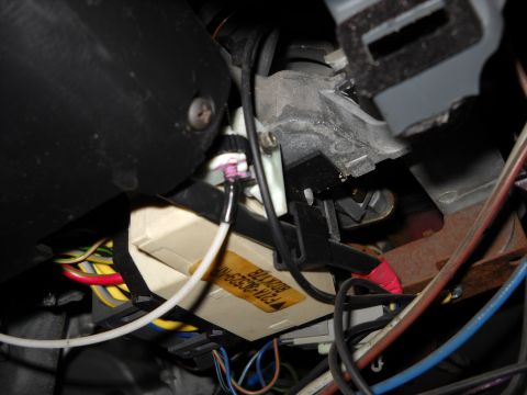 1993 Ford C-150 (Centurion Conversions) - Vehicle steering column wiring harness detail with a part number visible on a yellow label.