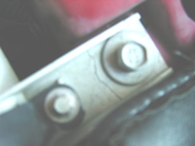 1997 Ford Taurus - Bolts and bracket visible under the hood of a vehicle.