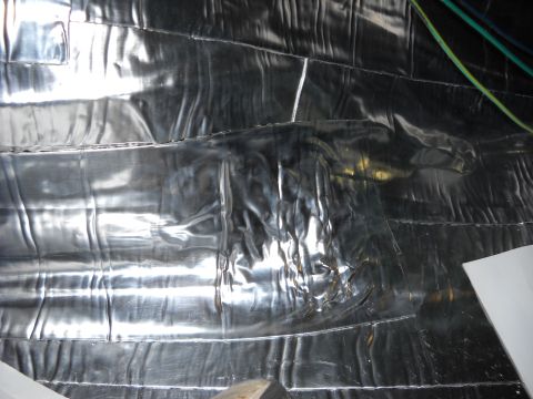 1993 Ford C-150 (Centurion Conversions) - The photo shows a wall covered in reflective insulation material, with some wires present.