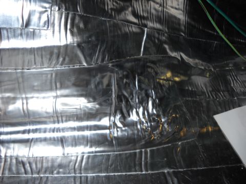 1993 Ford C-150 (Centurion Conversions) - The interior of the vehicle is covered in reflective insulation material, with some wiring visible.