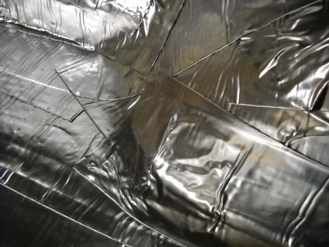 1993 Ford C-150 (Centurion Conversions) - Abstract pattern of silver metallic material with overlapping sections and creases.