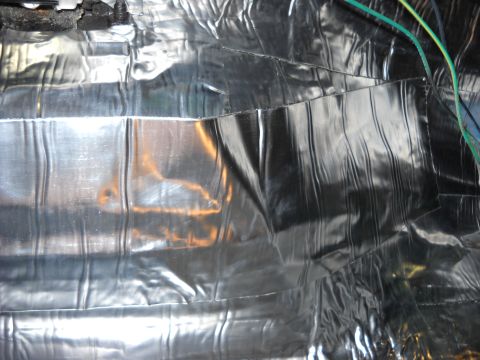 1993 Ford C-150 (Centurion Conversions) - Close-up of sound deadening material and wiring, likely from a vehicle's interior.
