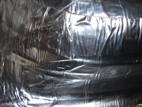 1993 Ford C-150 (Centurion Conversions) - The interior of the vehicle appears to be covered in a reflective, silver material with a textured surface.