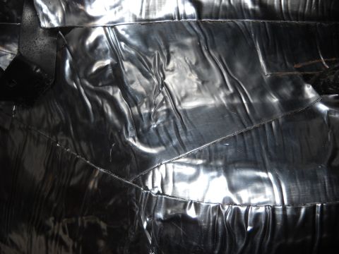 1993 Ford C-150 (Centurion Conversions) - Detail of the interior upholstery, showing a textured and reflective surface with stitched seams.