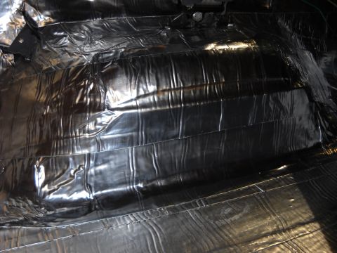 1993 Ford C-150 (Centurion Conversions) - Sound deadening material installed on the floor of a vehicle interior.