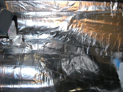 1993 Ford C-150 (Centurion Conversions) - The interior of the vehicle is covered in silver insulation material.