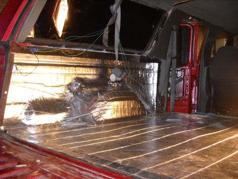 1993 Ford C-150 (Centurion Conversions) - Soundproofing installation in progress inside a vehicle's cabin.